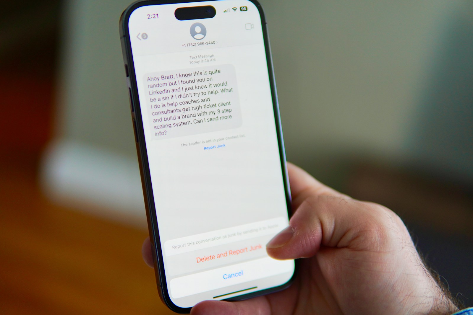 Telefoon met een verdacht sms-bericht en de knop om het te melden als ongewenst